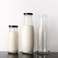 Free Sample Reusable Factory Cheap Price Transparent Glass Bottle for Milk Juice Beverage with Lid