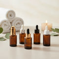 Wholesale Amber Clear Skin Care Essence Glass Dropper Bottle 30ml 2 oz with Gold Stamping and Screen Printed Design