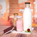 Stocked Cheaper Price Round Clear Transparent Milk Bottle Glass for Juice Beverage Packaging