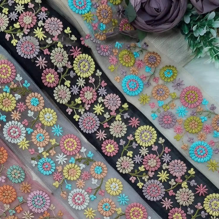 Custom made in  2.5 inch width on cotton base fabric floral embroidered laces in four colour ways for garments and for resale.