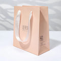 Custom Logo Naked Pink Paper Boutique Paper Bag Gift Bag With White Handle Ribbon for Cosmetic