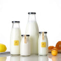Best Selling Custom Clear Empty Juice Beverage Ice Tea Coffee Milk Glass Bottles With Lid