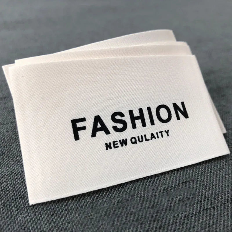 Cheap Free Made Design Woven Clothing Labels Personalized Price Satin Pink Glitter Silk Center Fold Washable Adhesive Label