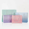 Luxury Pink & White Cardboard Shopping Paper Bag with Gold Foil Handles Printed Logo for Clothing Packaging Exhibitions