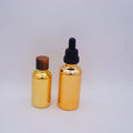 1Oz Round Gold Glass Bottle With Serum Pump