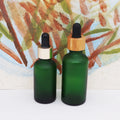 50ml 100ml Empty Round Cosmetic Frosted Green Essential Oil Dropper Bottle with Bamboo Cap