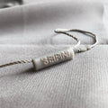 High Quality Nylon String Custom Design Brand Embossed logo Cylindrical 7*25mm Plastic Hang Tag String Label Seal Tag