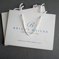 Wholesale Custom Luxury Recyclable Kraft Paper Bags with Ribbon Handles Printed Shopping Bag for Clothing and Your Own Logo
