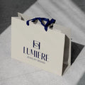 Custom Recycled Ivory Clothes Packaging Gift Bag With Ribbon Handle Luxury Cream Beige Shopping Paper Bags With Your Own Logo