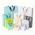 Wholesale Custom Designed Paper Bags with Ribbon Handle for Clothing Shoes Underwear Featuring Your Own Logo