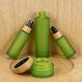 Premium Green Frosted Glass Jars & Bottles with Bamboo Caps for Cosmetics Support Customization