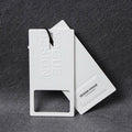 Luxury White Textile Paper Hang Tag Swing Tag With Embossed Debossed Die Cut Design Black Foiled Logo With String Cord