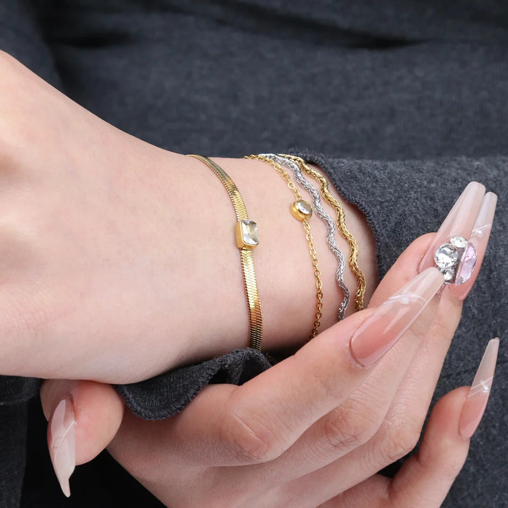 Chris April 316L Stainless Steel PVD Gold Plated Herringbone Flat Snake Emerald Cut Zirconia Charms Bracelet