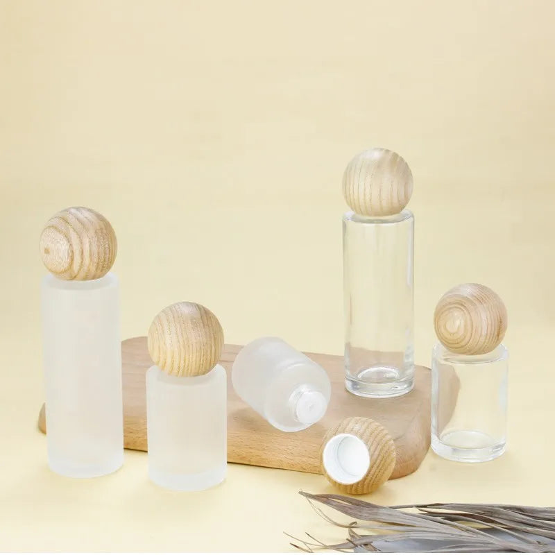 Eco Friendly 20ml 30ml 60ml 80ml Cylindrical Flat Shoulder Bottle Aromatherapy Essential Oil Bottle with Round Wooden Cap