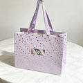 Custom Shopping Paper Bags for Clothing Gift Bag with Ribbon Handle Custom Laser-embossed Foil Paper Bag with Your Own logo
