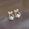 Micro Zircon Bow Pearl Earrings for Women Gold Plated Shell Pearl Stud with Hollow Rhinestones for Weddings