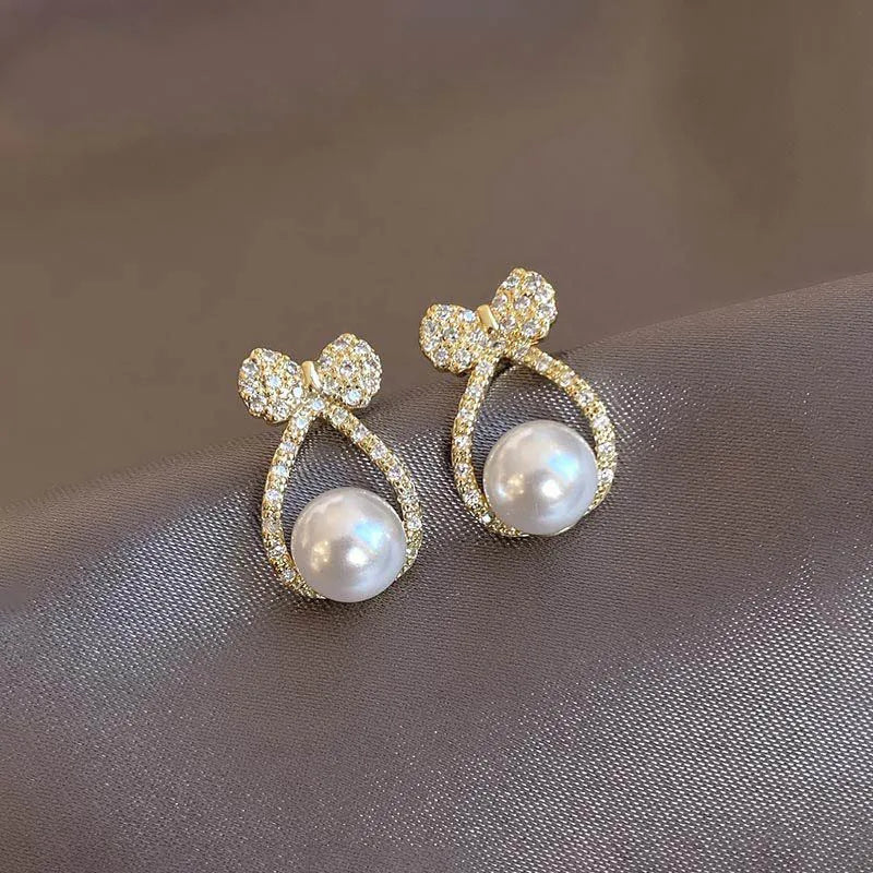 Micro Zircon Bow Pearl Earrings for Women Gold Plated Shell Pearl Stud with Hollow Rhinestones for Weddings