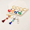 Wholesale Cute Car Key Holder Electroplating Gold Color Evil Eye Key Chain With Tassel