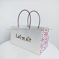 Best-selling Heavy Duty Reusable White Cardboard Handle Bags Sturdy and Foldable for Retail Gift Shops and Cafes