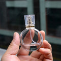 Wholesale Custom 25ml 30ml 50ml Oblate Shape Transparent Glass Perfume Bottle With Aluminum Sprayer