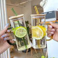 Wholesale Clear Square Glass Mug Cup for Iced Drinks Beer Cola Soda with Colorful Handles Bamboo Lid Colorful Straw