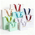 Wholesale Custom Designed Printed Paper Bags with Ribbon Handle for Clothing Shoes Underwear Featuring Your Own Logo