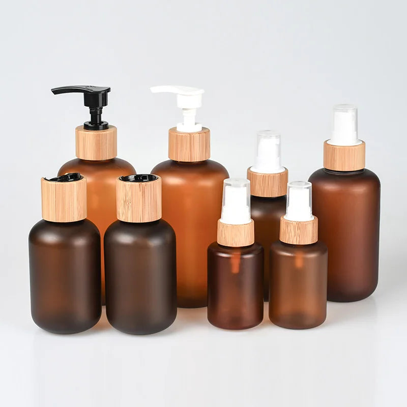 Eco-friendly PET Cosmetic Bottles 30ml-500ml Frosted Amber Lotion Containers with Bamboo Caps Pump PP Base and Plastic Lid