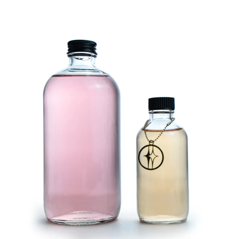 Popular 250ml Boston Round Clear Frosted Glass Bottles with Black Plastic Lids for Liquor Juice Cold Brew Coffee