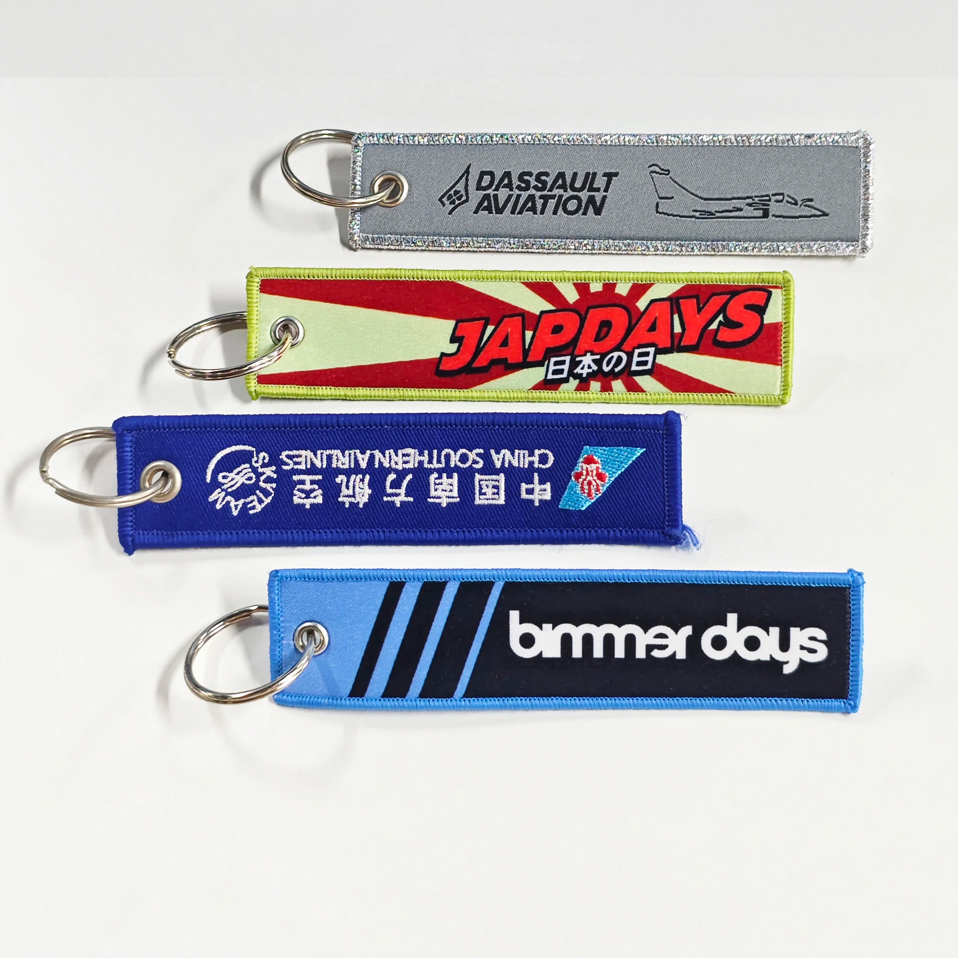 Wholesale Customized Remove Luggage Tag Label Before Embroidery Keyring Flight for logo Woven Keychains