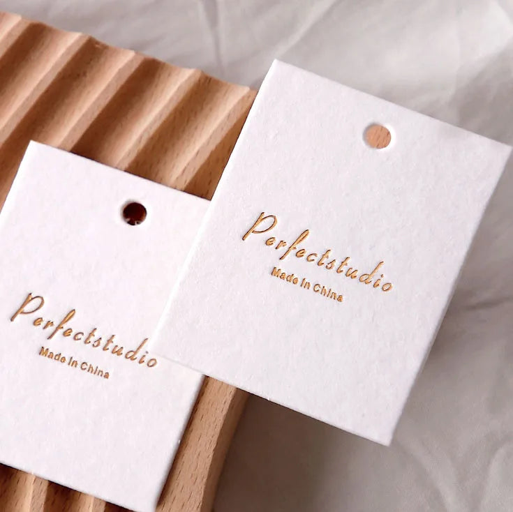 Wholesale Price Texture Cotton Garment Tags for Clothes Custom Printing logo Embossed Design Round Shape Paper Swing Tag