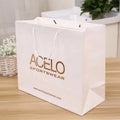 Custom Rose logo Brand Gold White Cardboard Paper Shopping Packaging Gift Bags for Clothing Foil Stamping with Own logo