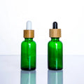 Wholesales 5ml 10ml 15ml 20ml 30ml 50ml 100ml Frosted Green Blue Amber clear Essential Oil Glass Dropper Bottle with Bamboo Lid