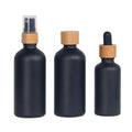 Eco-friendly 30ml 50ml 100ml Matte Black Glass Essential Oil Bottle with Bamboo Spray Caps