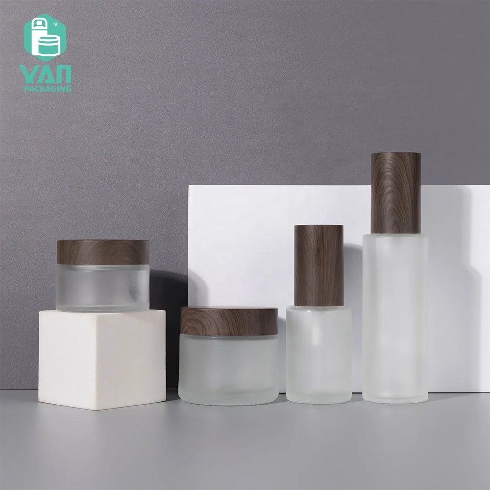 YAN Packaging 1 oz 2 oz Frosted Glass Jars Water Transfer Wood Color Lids 30ml 60ml Spray Pump Bottle for Face Cream Engraving