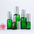 5ml to 100ml Round Green Glass Cosmetic Bottle with Silver Golden Pump Lid for Essence Creams and Face Creams