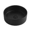 Handmade Ceramic Matte Black Round Fluted Wash Basin in the Bathroom Above the Counter