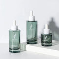 Cosmetic Skincare Serum Essence Packaging Green Glass Bottle Flat Shoulder Essential Oil Dropper Bottle 15ml Plastic Caps