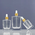 Clear Glass Oil Bottle with Dropper 30ml 50ml 100ml Sizes Flat Squared Essential Oil Bottle for Skin Care Cream and Serum
