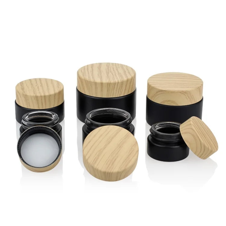 Custom logo Small Package 10g 15g 20g 30g 50g 60g Black Glass Jar with Wood Grain Cap for Cosmetic Facial Essence Cream