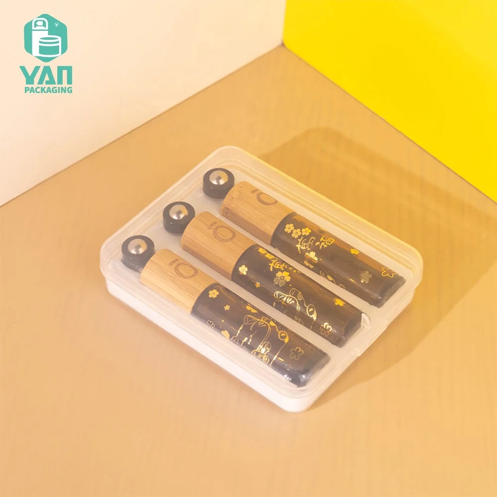 YAN Luxury 10ml Amber Cylinder Glass Perfume Oil Set Roll on Sample Bottles with Bamboo Cap and Plastic Box Customizable Logo