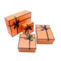 Factory Custom Luxury Orange Rigid Paper Cardboard Gift Packaging Rectangle Boxes with Ribbon Embossed Skincare Cosmetics Set