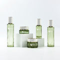 Luxury Green Glass Lotion Bottles Cream Jars Set 30g 50g 40ml 100ml 120ml Capacities Cylinder Shape Screw Cap for Skincare