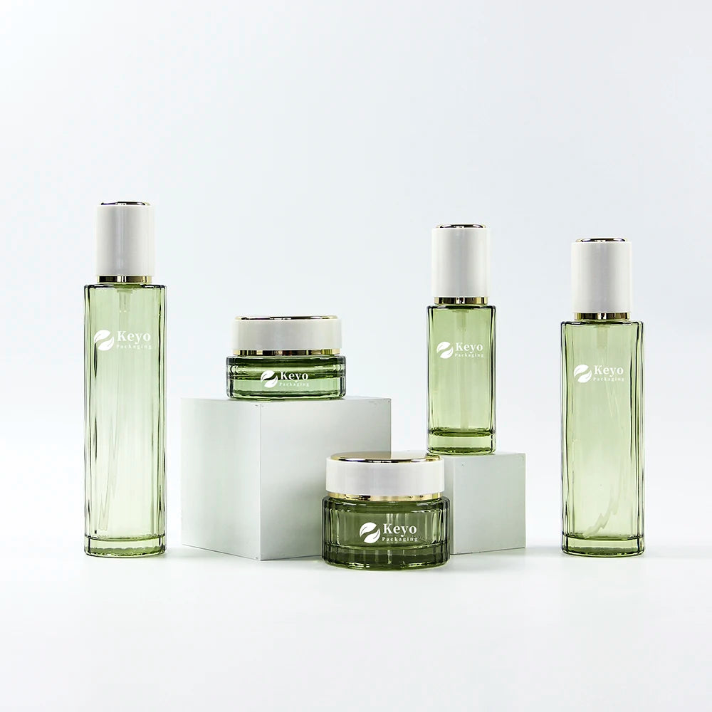 Luxury Green Glass Lotion Bottles Cream Jars Set 30g 50g 40ml 100ml 120ml Capacities Cylinder Shape Screw Cap for Skincare