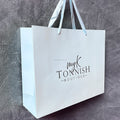 Luxury Retail Shopping Boutique Paper Bags Custom Printed logo Luxury Clothing Shopping Brown Paper Bag with Handle