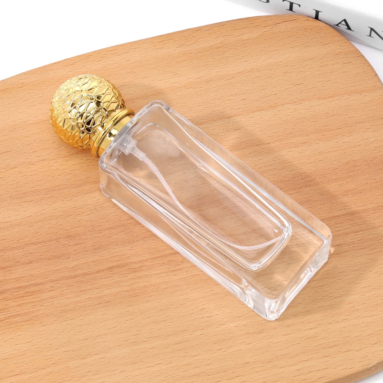 Factory Price 50ml Glass Perfume Bottle with Gold for Ball Lid Thick Bottom Empty Crown Cap Sealing Cylinder Shape