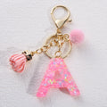 Manufacturer's New Eco-Friendly Metal Keychain Cute Pink Fur Ball Tassel Pendant with Sequin Letter for Girls' Bags