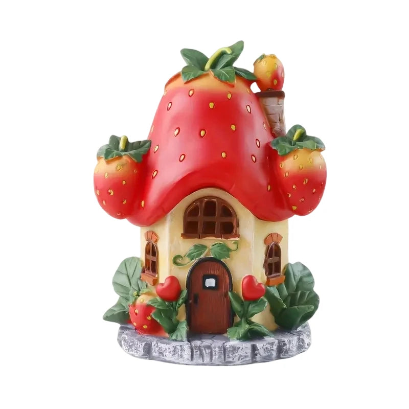 Solar-Powered Strawberry Fairy House Garden Light with Red Berry Roof and Green Leaves on a Beige Cottage