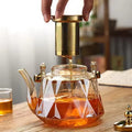 New Design Hot Sale 1000ml High Borosilicate Heat Resistant Diamond Glass Teapot with Copper Handle and Strainer