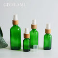 Empty 15ml 30ml 50ml 100ml Natural Packaging Round Clear Green Fine Mist Spray Bottle with Bamboo Wooden Lid for Skin Care