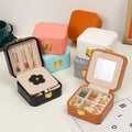 2025 Portable Mini Jewelry Case Travel-friendly Leather Jewelry Box with Mirror for Rings Earrings Necklace